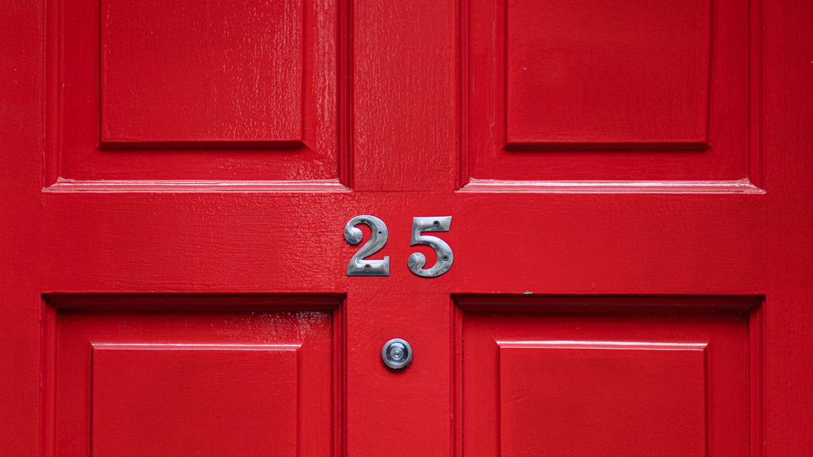 The number 25 is displayed above a door.