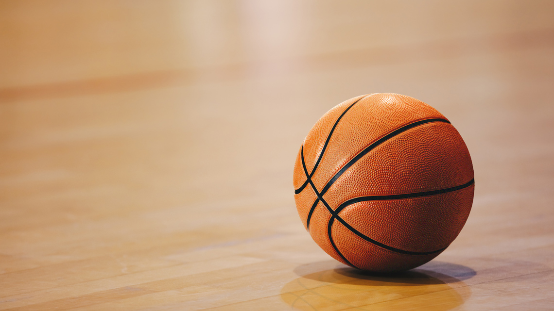 A basketball resting on the ground.