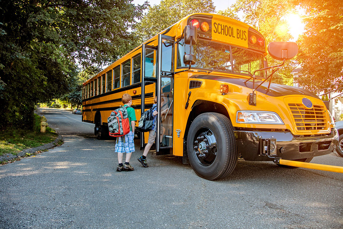 Children boarding a school bus.