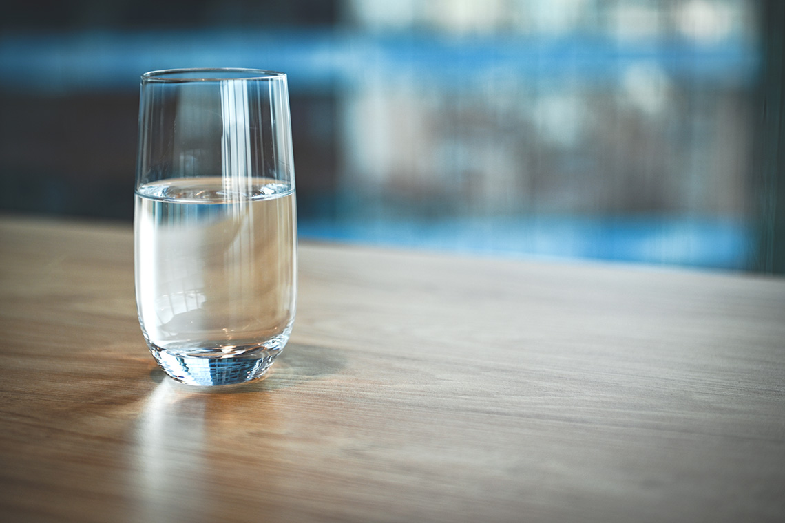 A glass of water on a table.