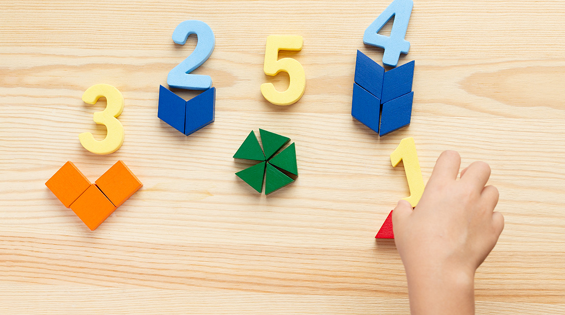 Wooden number and shape blocks arranged on a table.