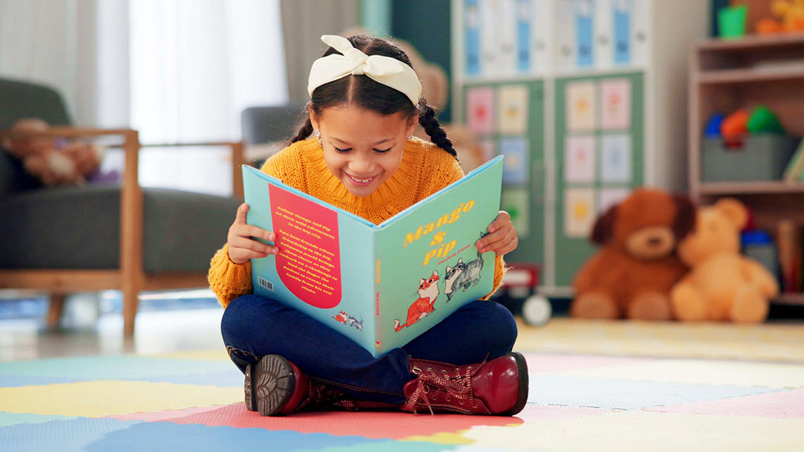 A learner is reading a picture book.