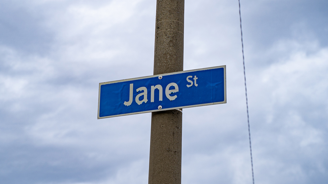 A street name sign on a pole.