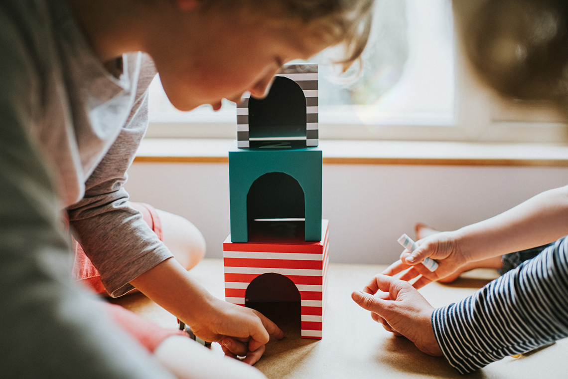 Making a tower A child builds a town in their room.
