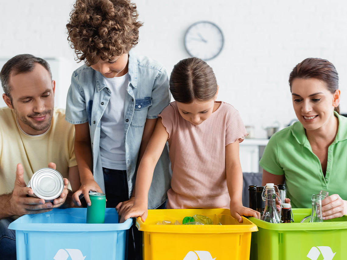 Learners sorting garbage in recycling bins.
