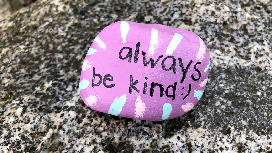 A rock with the words “always be kind” painted on it.