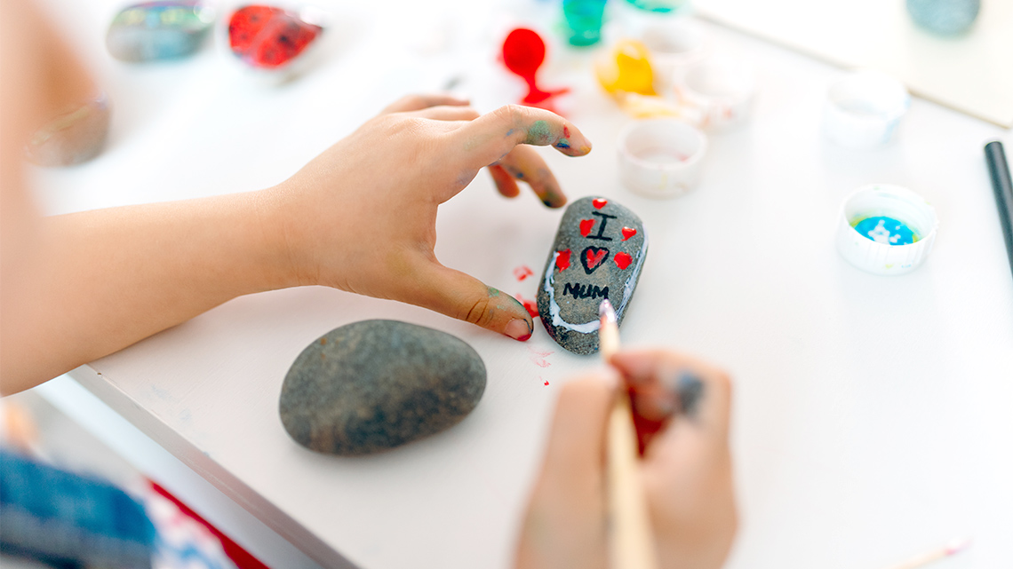 A rock with the words “I love mum” painted on it.