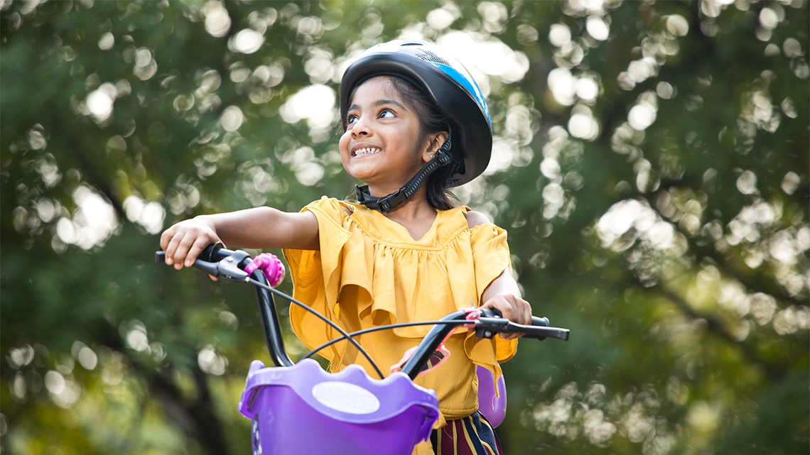 A kid riding a bike.