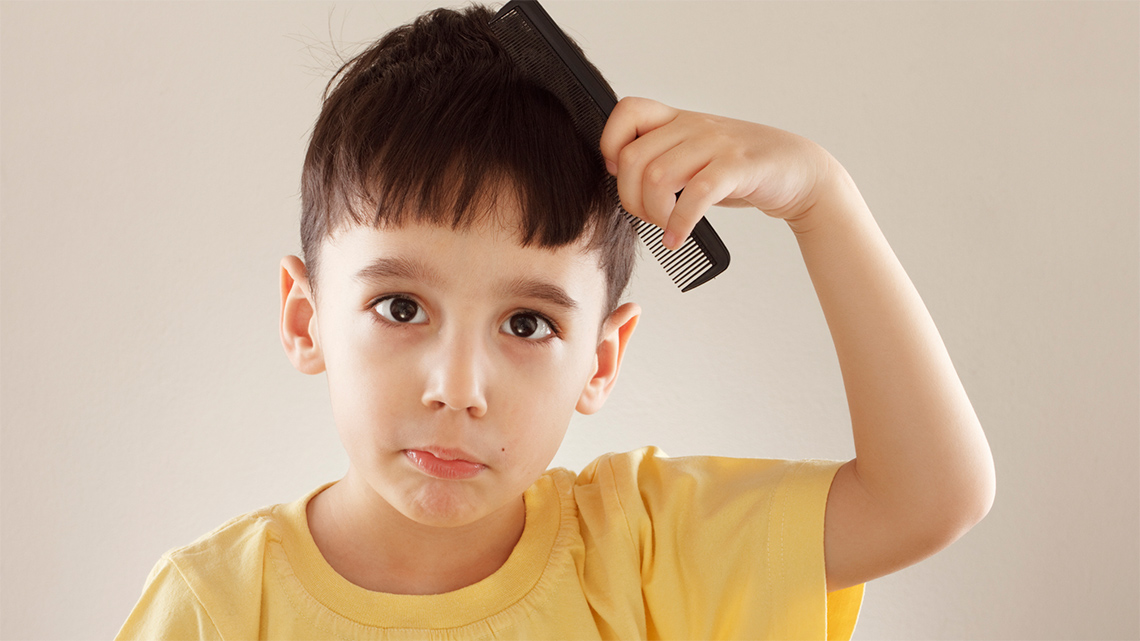 A kid brushing their hair. 