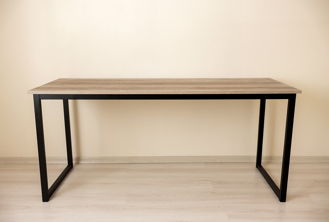 A table with a metal frame and a wooden top.