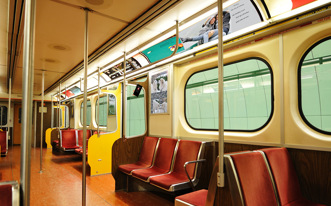 interior of a subway train filled with advertisements