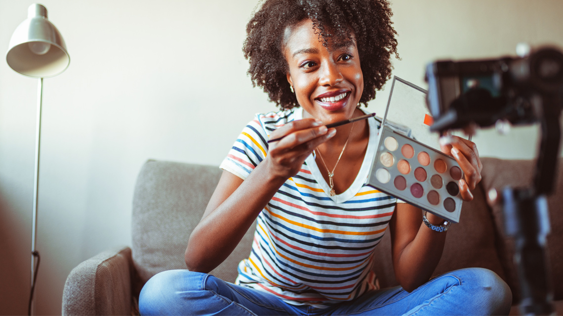 A person is holding out a product in front of a camera, trying to sell it.