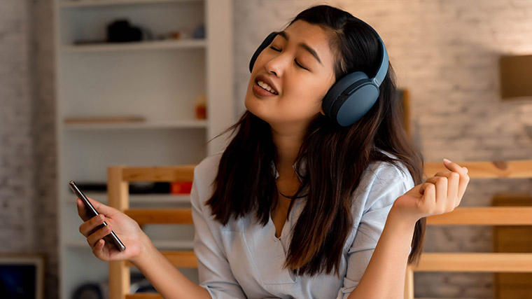 A girl singing with a microphone recording device