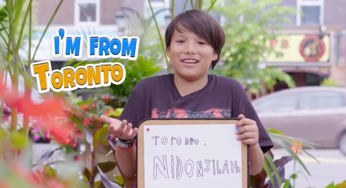 Jacob holds a sign with an Ojibwe translation of “I’m from Toronto” to “Toronto, Nidonjibah!”