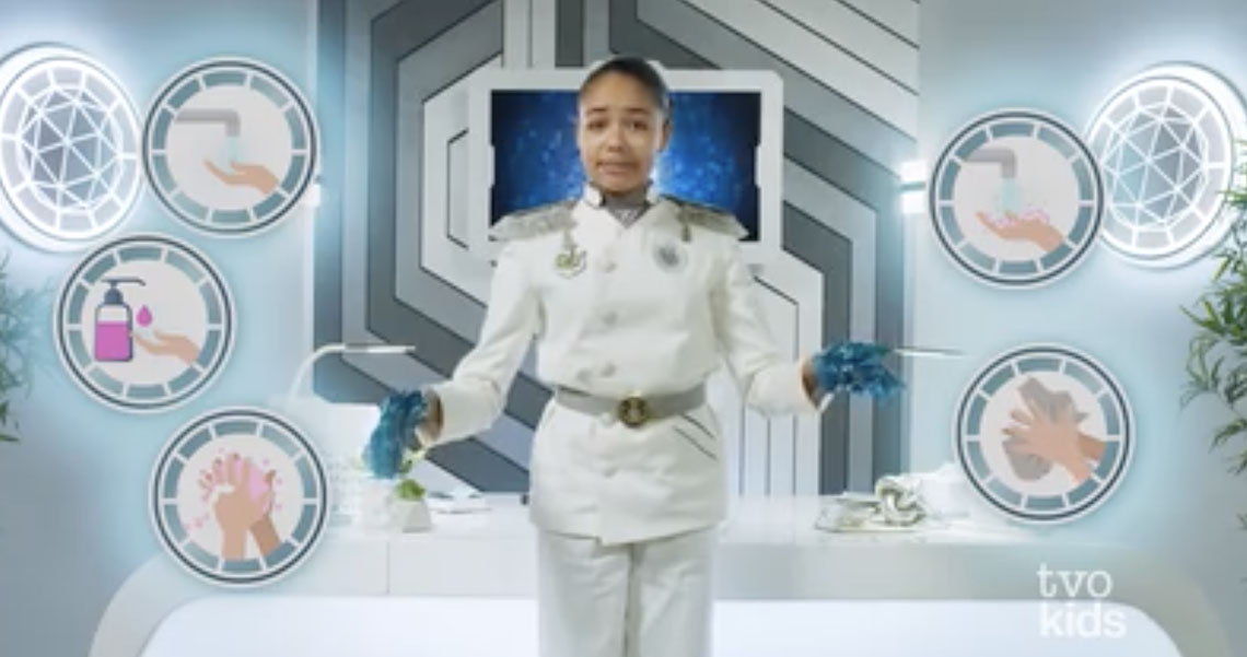 Big O standing with her hands covered in sticky substance. Icons of the steps of washing hands are included in the photo.