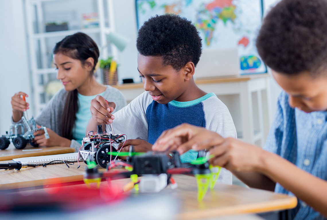 A student fixing a robot.