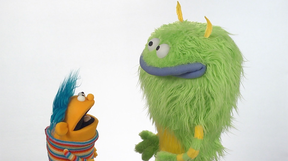 Frank is beside Frankie and smiling as they share their poem with Frankie.