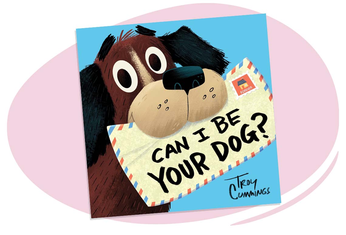 Brown dog holding a mail/letter with the words, “Can I be your dog?” on the front of the envelope.