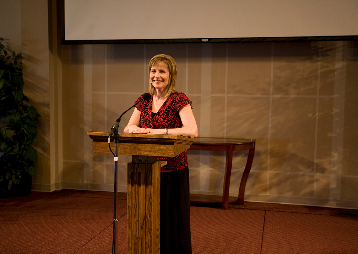 A principal standing at a podium.