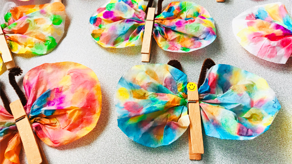 Colourful butterflies made from coffee filters, clothes pins and pipe cleaners