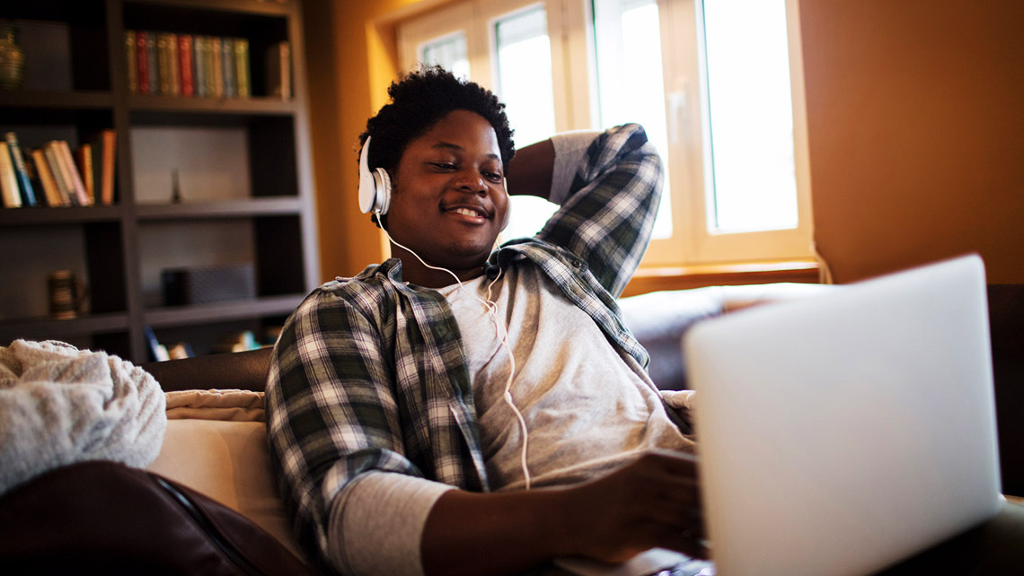 Student using headphones while watching a video