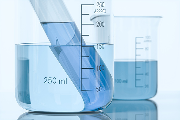 a scale being used to measure mass of fluid in a beaker