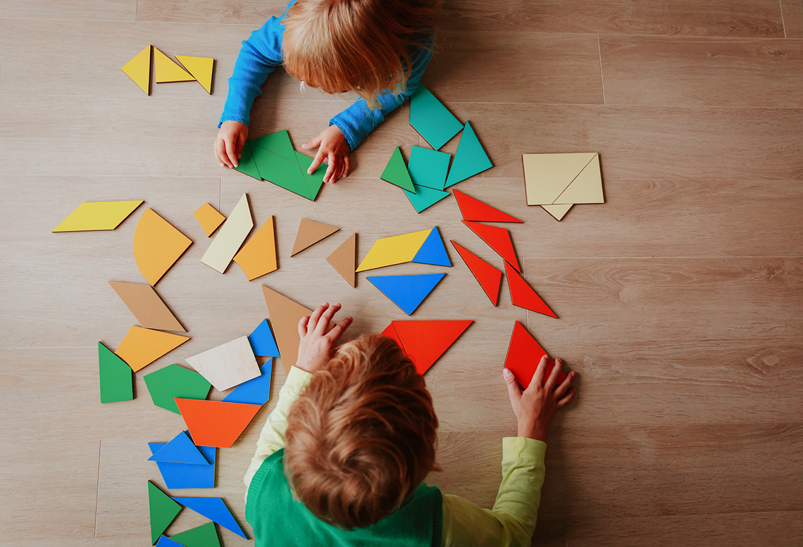 Children playing with shapes and blocks.
