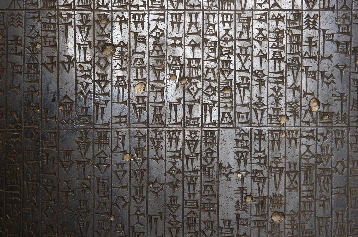 Ancient symbols etched on a stone slab.