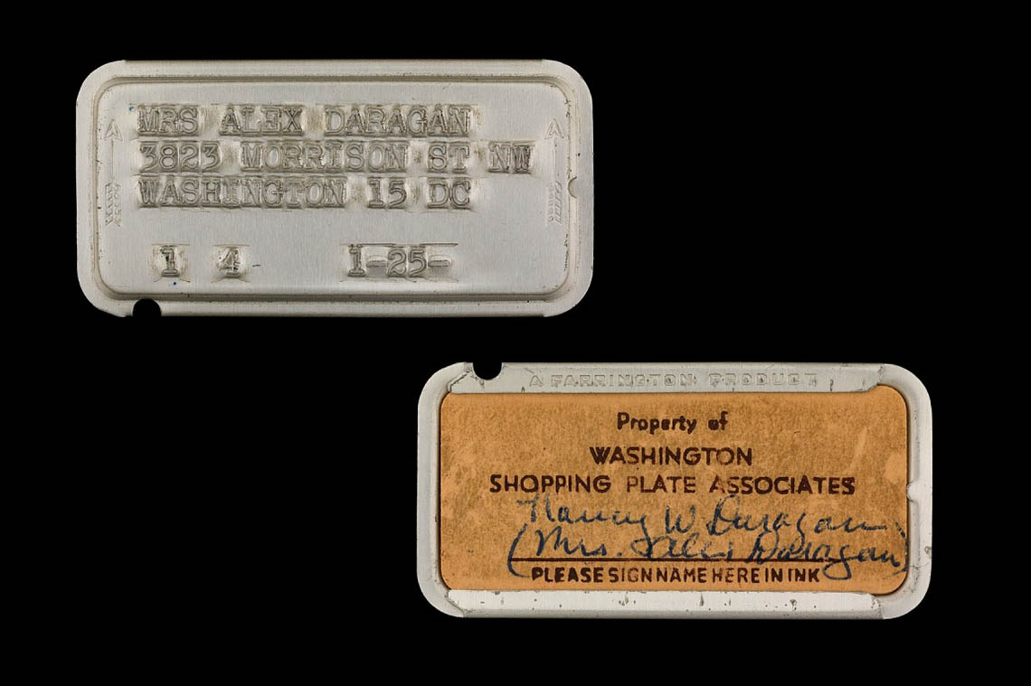 A small metal plate with text imprinted on it.