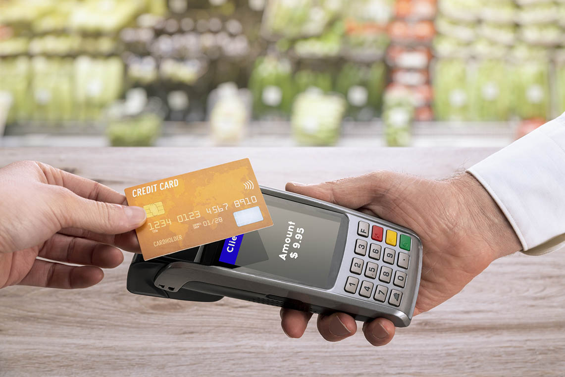 A chip credit card with a name and account number on it.