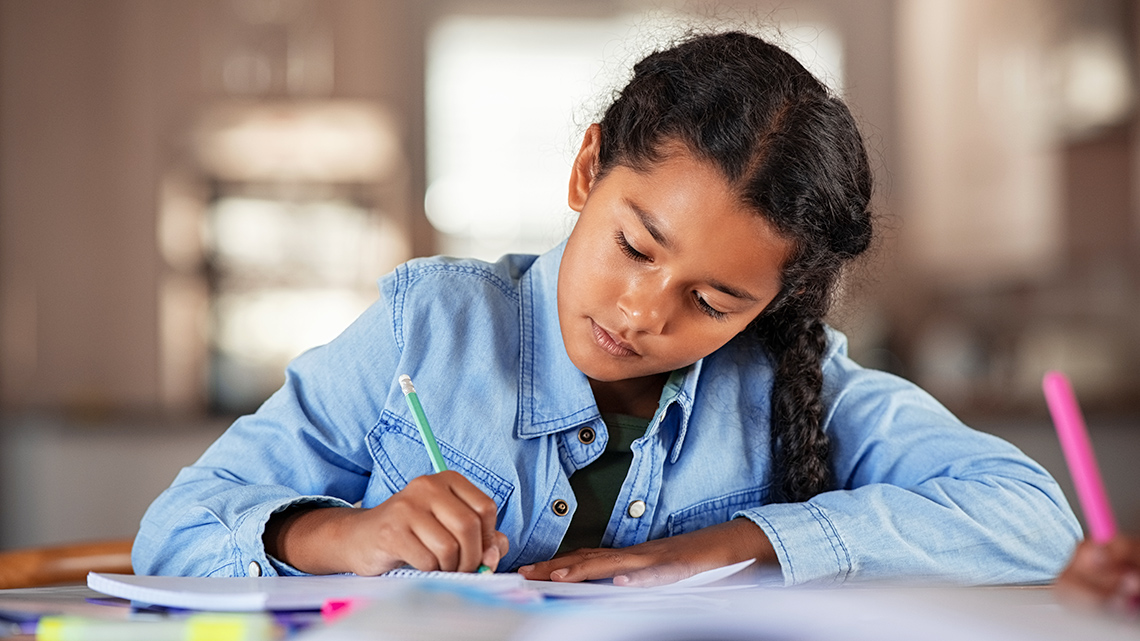 Student writing in notebook