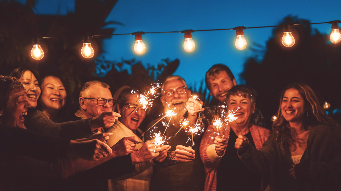 Nine family members, smiling and celebrating.