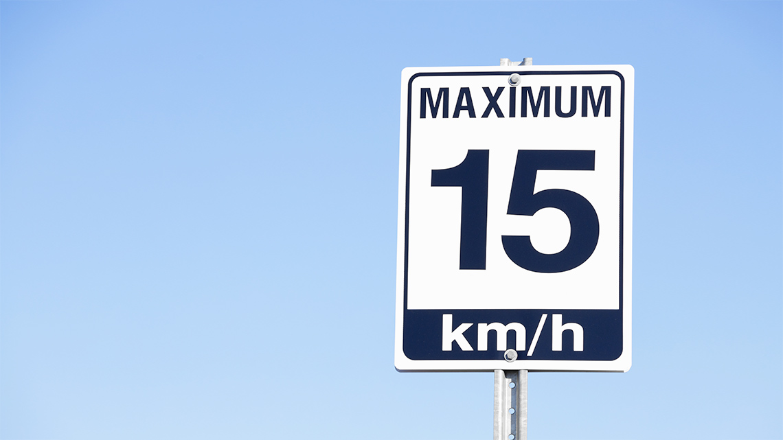 A road sign that reads maximum 15 km slash h (kilometres per hour)
