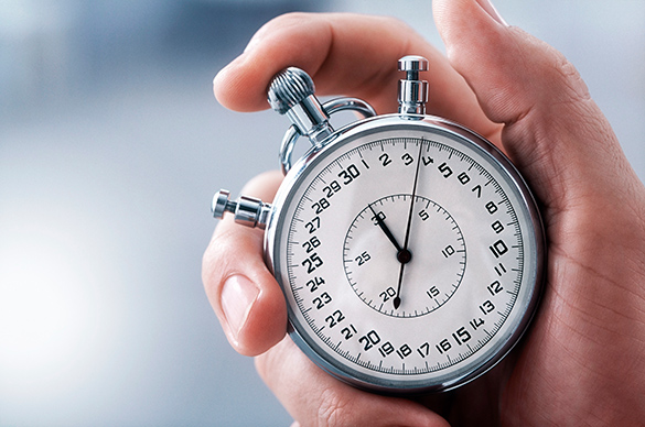 Person holding a silver stopwatch.