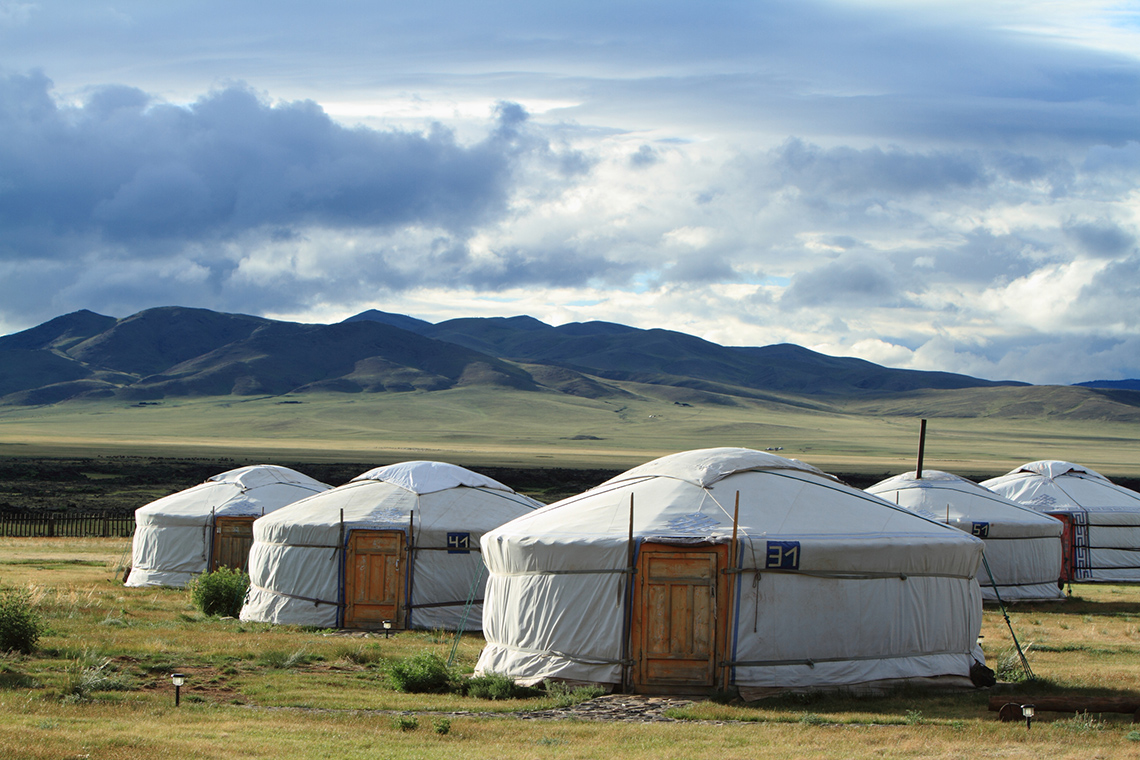 5 yurts, which are huts with a cylinder base and rounded triangle roof.