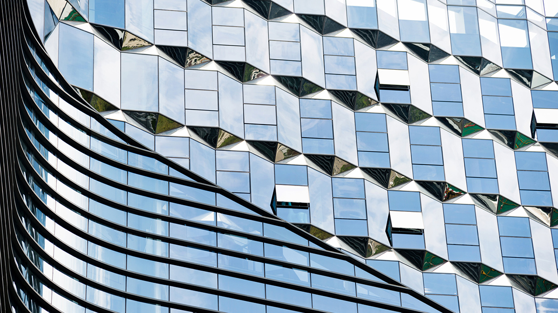 The side of an office building. There are several rectangular windows.