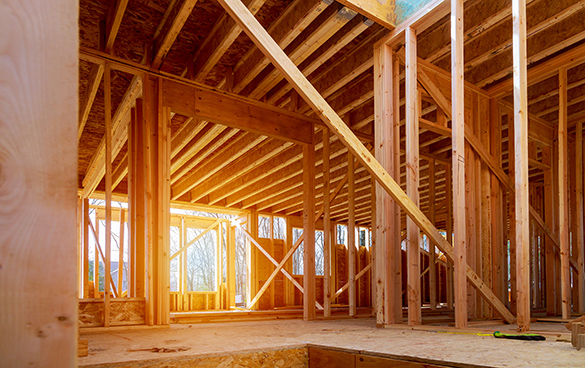Inside the wooden frame of a house.