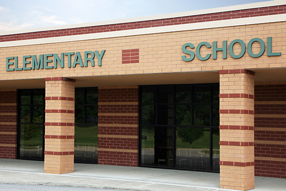 Front Face of a School Building The front exterior of a school building with two large windows.