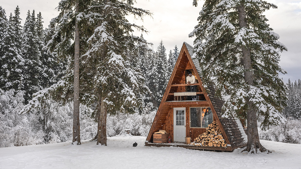 A small two-storey cabin in the shape of a triangle.