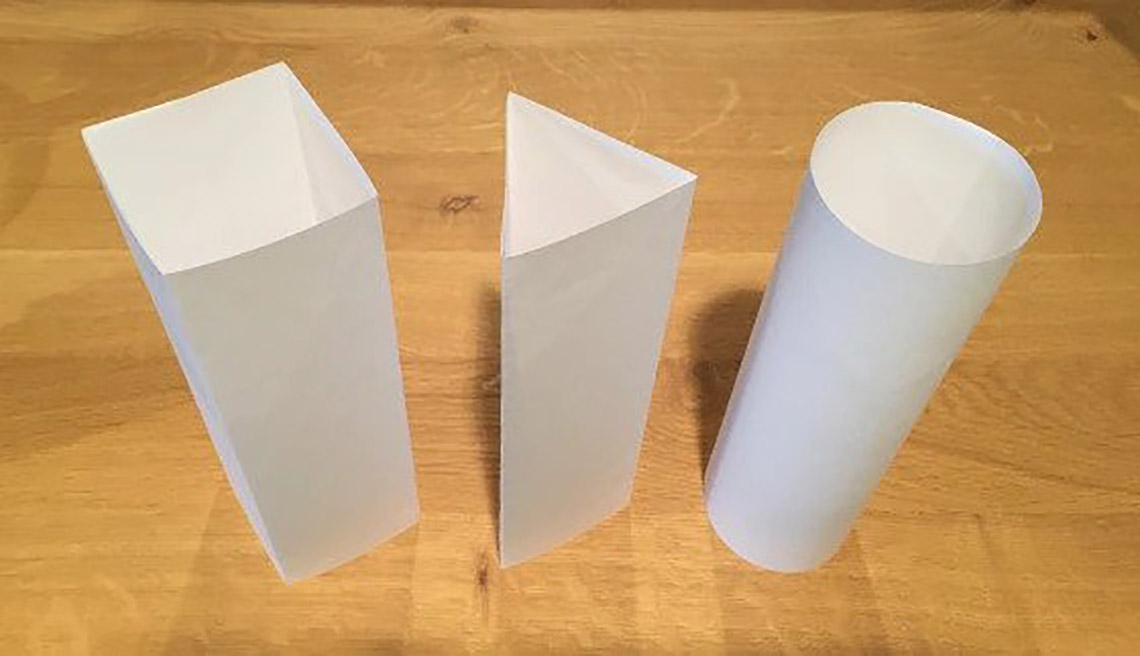 Three differently shaped columns made of paper: a square column, a triangular column, and a circular column.