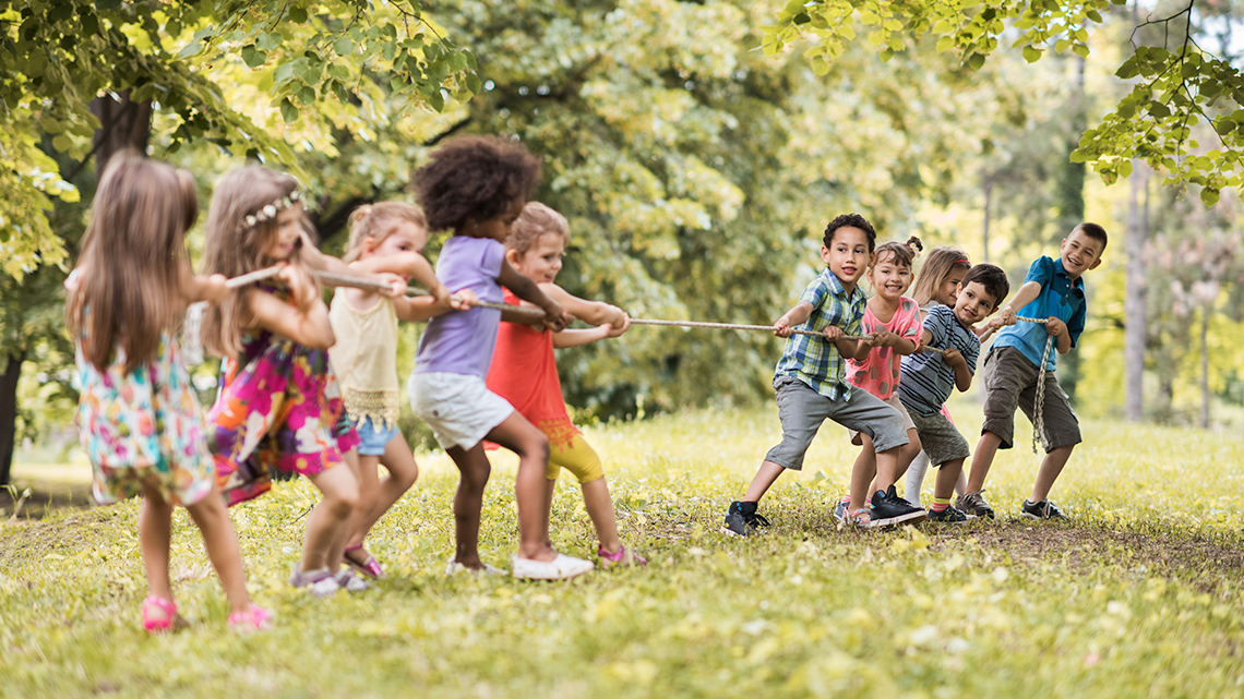 A group of kids playing tug of war