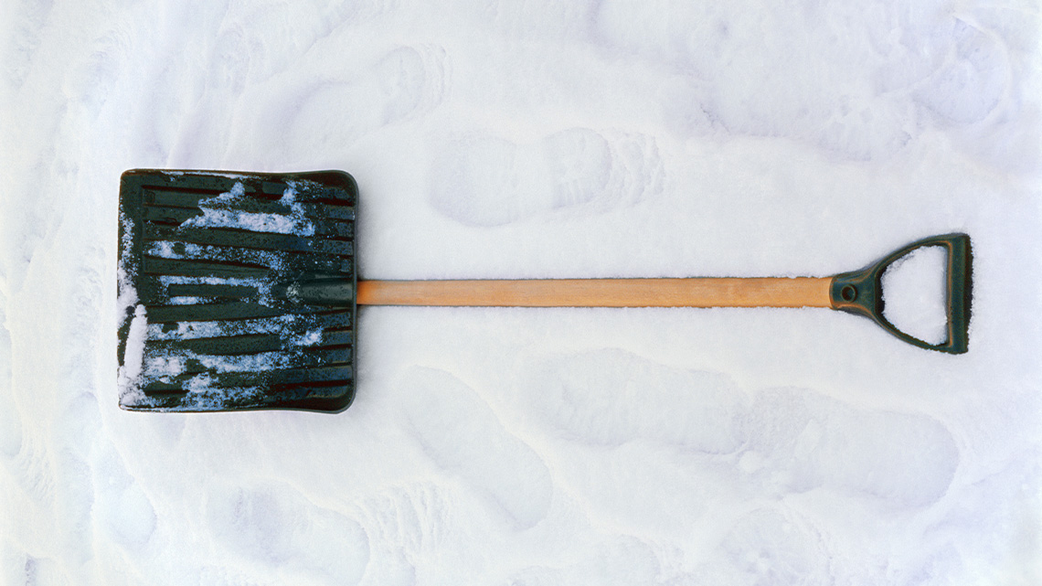 A snow shovel with a plastic handle on one end and a large scoop on the other.