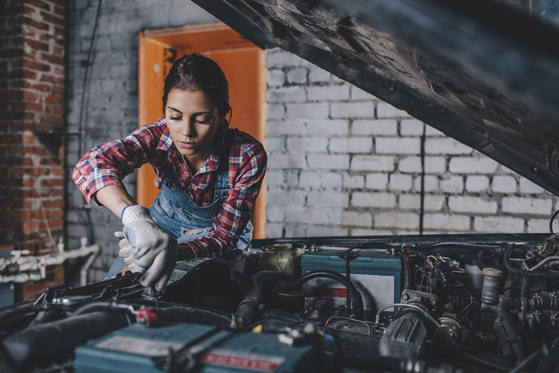 A mechanic repairing a car engine.