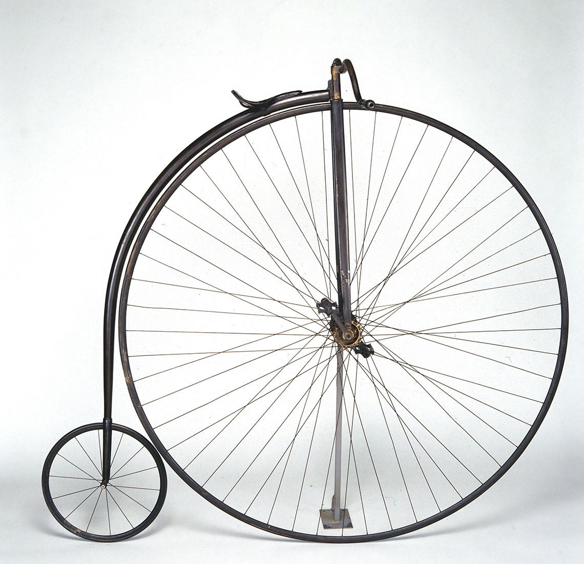 A bicycle made with one very large wheel and one small wheel.