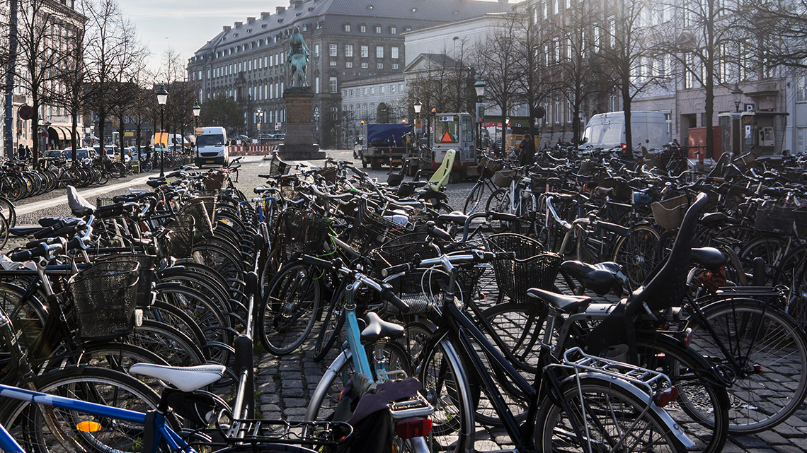 A large number of bicycles locked up together in Copenhagen, Denmark.
