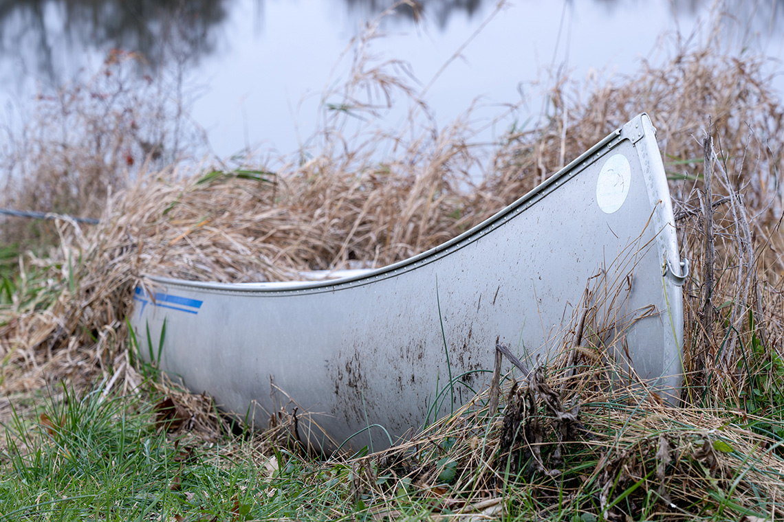 Aluminum canoe with a metal frame held together with metal bolts.