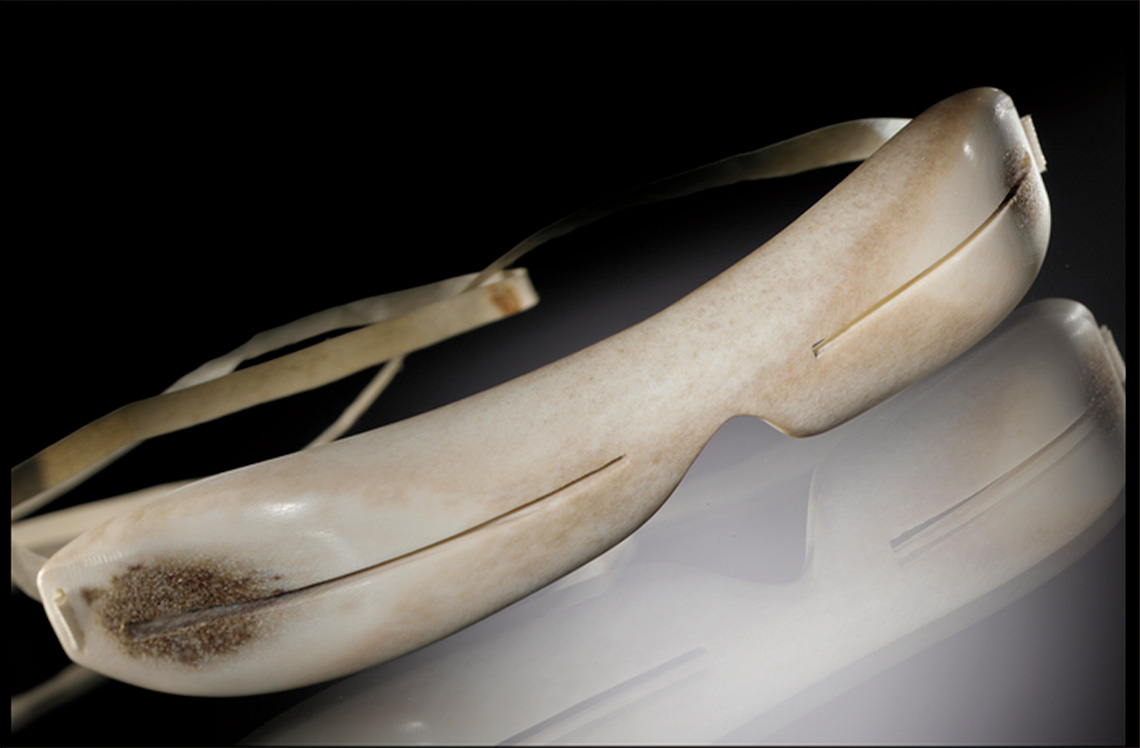 Snow goggle Snow goggles made with carved caribou bone and with a caribou strap. Narrow slits is carved through the bone on each side of the goggles.