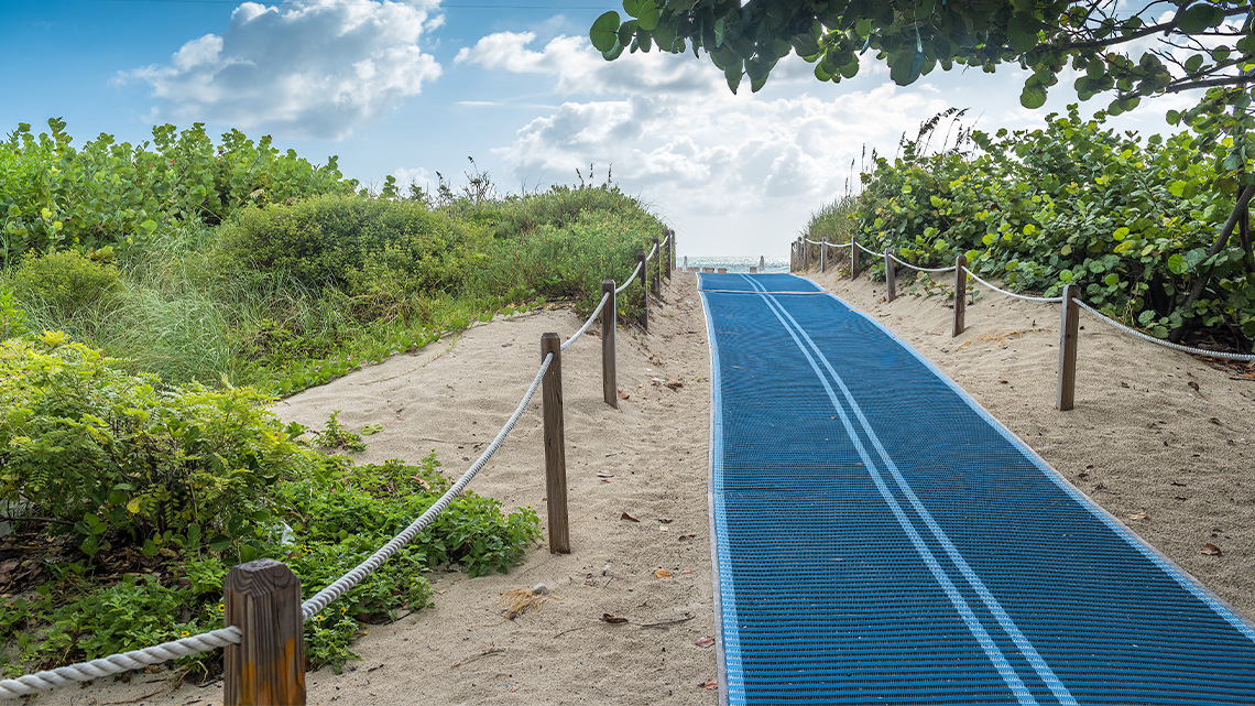 Blue pathways on sand for wheelchairs