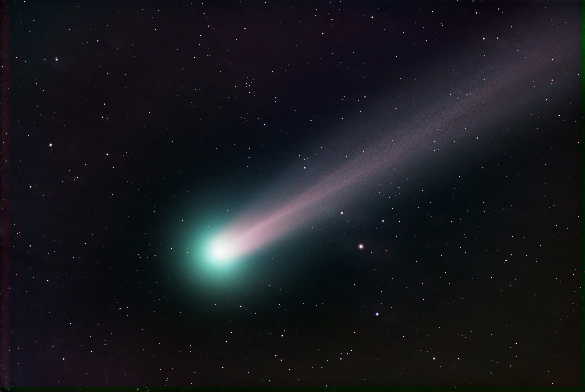 A comet: a glowing green and white orb with a pink and purple tail streaking through the night sky.