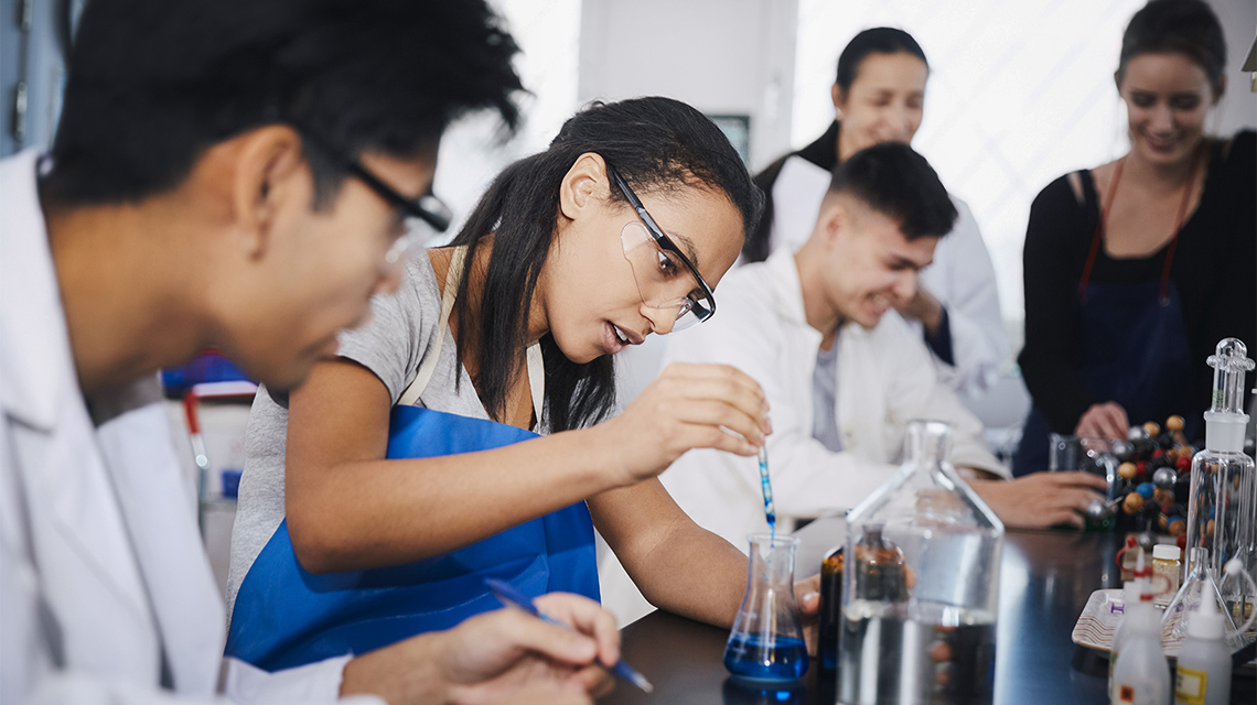 Scientists working in a lab mixing solutions.
